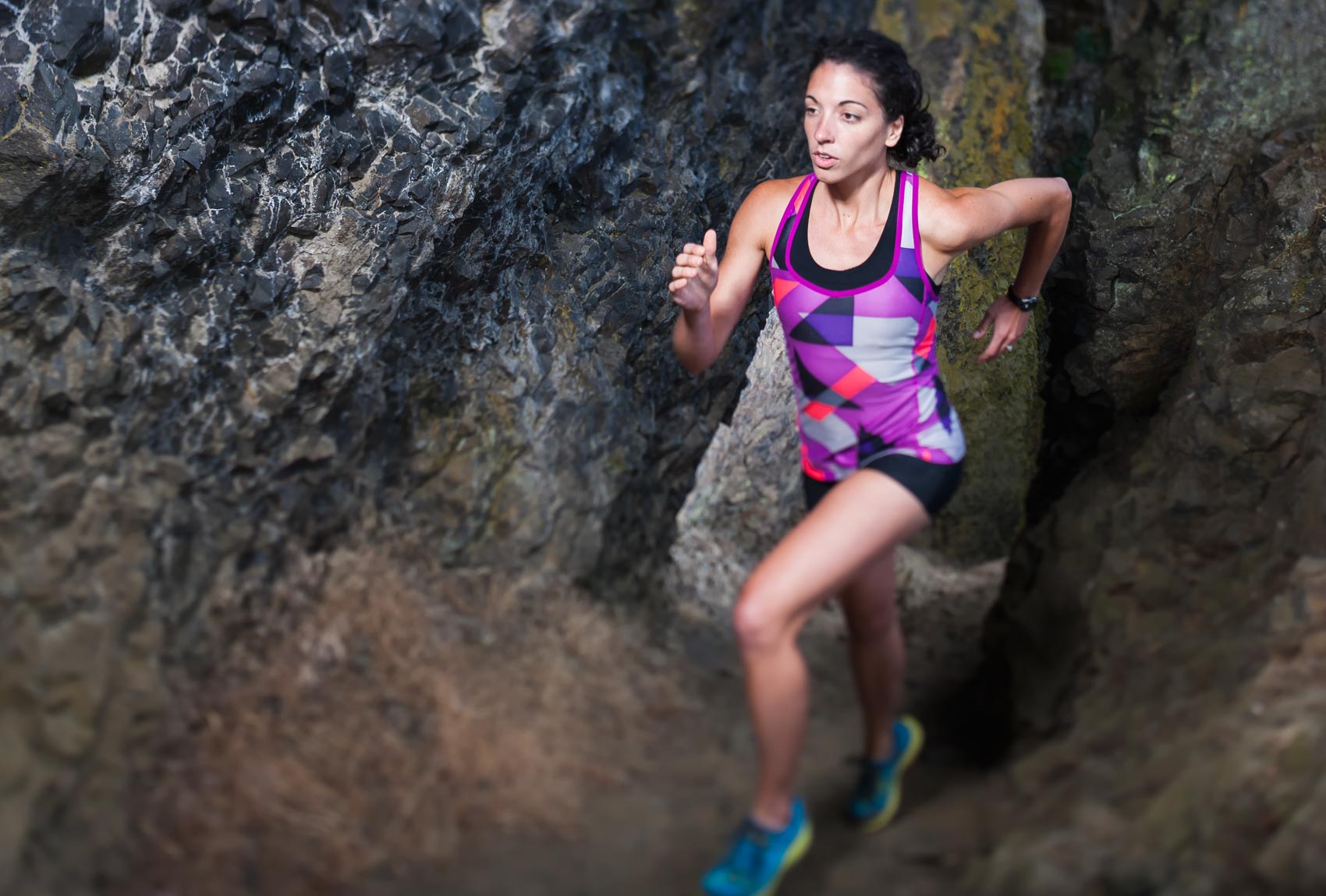 Commercial photographer Portland - woman running between rock walls