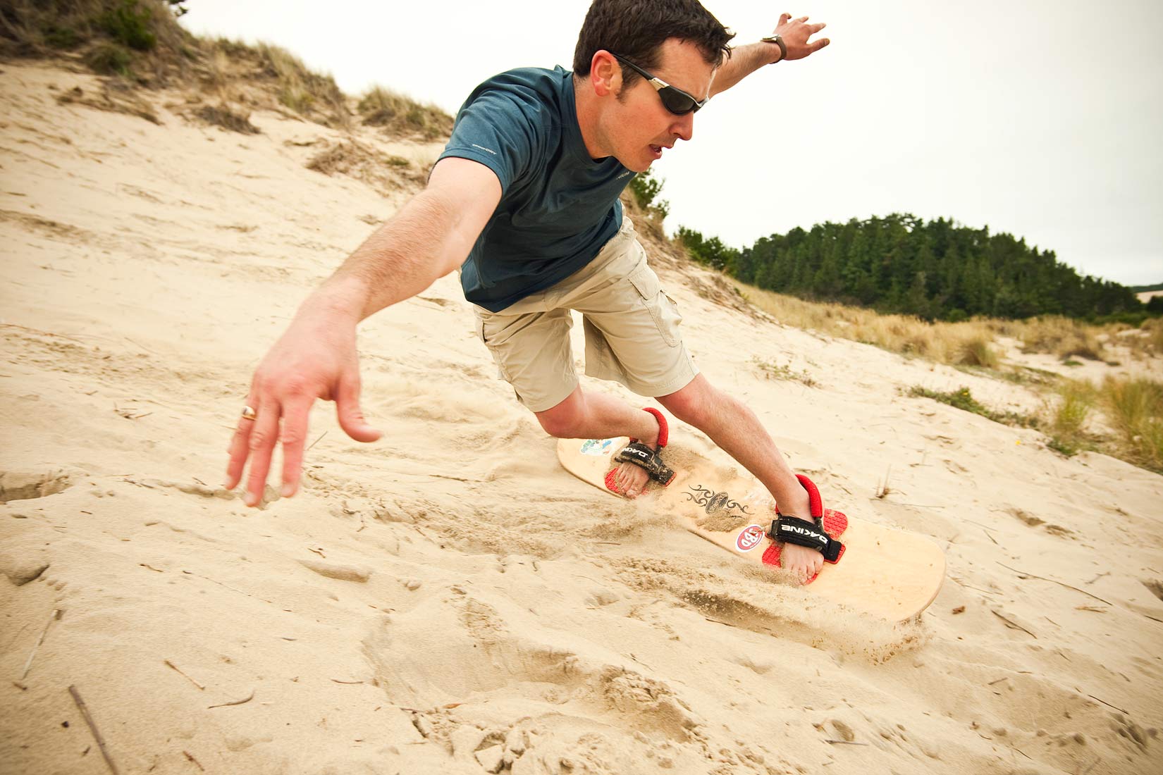 Advertising photographer Portland - man sand boarding on the Oregon coast