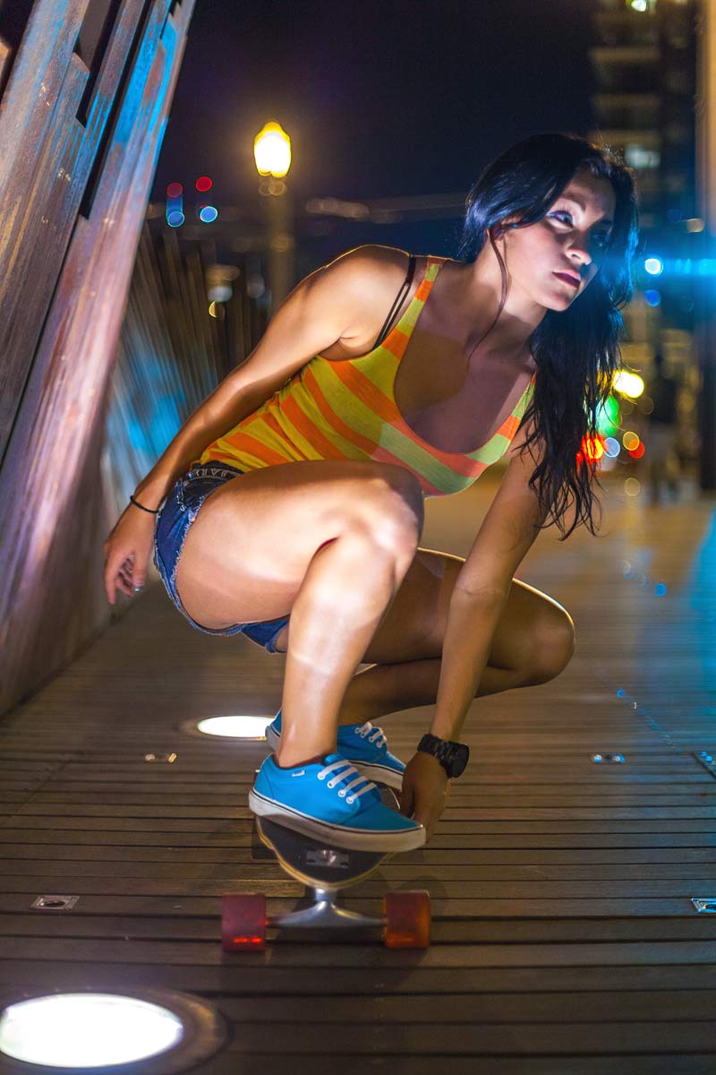 Woman on skateboard at night in Portland urban area