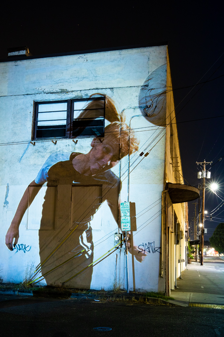 Pprojected photograph onto a building at night  of a US woman