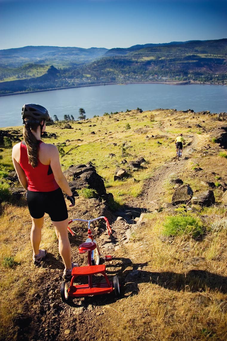 Commercial concept  photography of woman with tricycle on trail in Oregon Columbia River Gorge. 